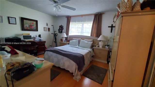 bedroom with hardwood / wood-style flooring and ceiling fan