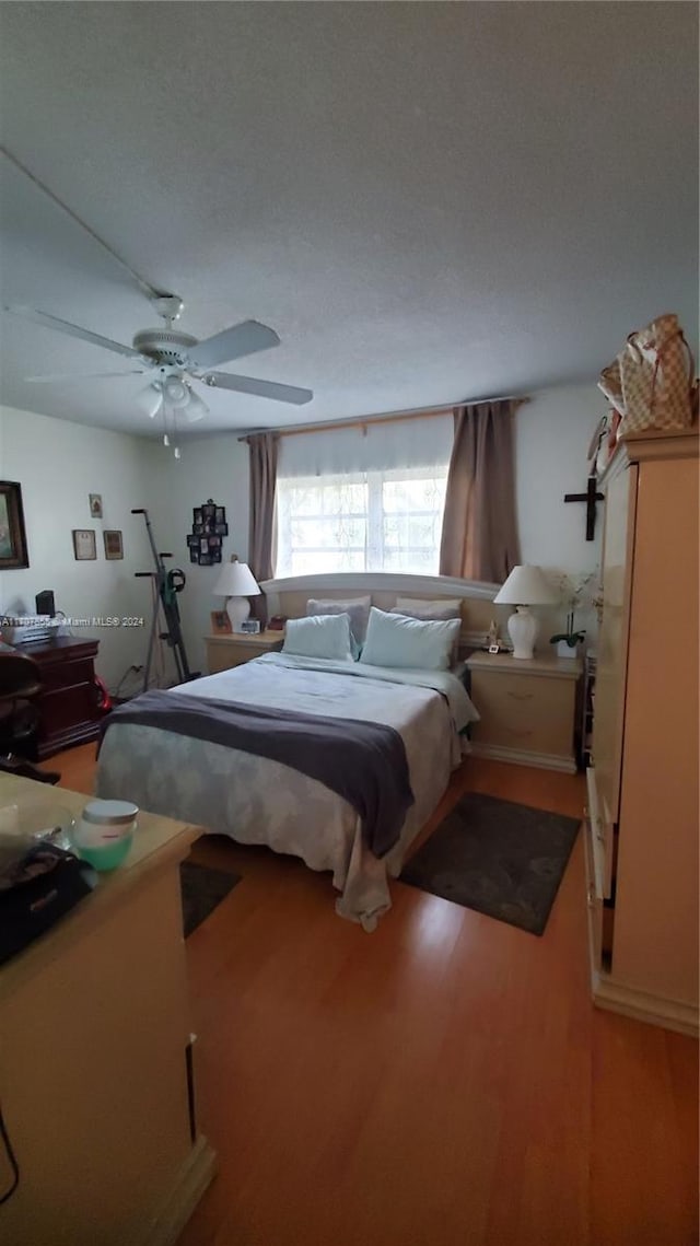 bedroom featuring hardwood / wood-style floors and ceiling fan