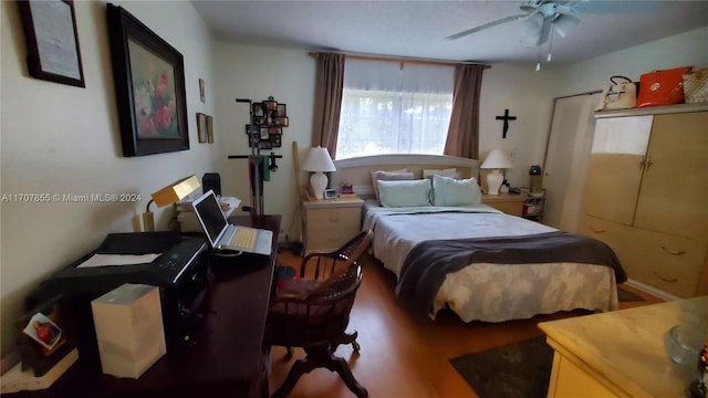 bedroom with hardwood / wood-style floors and ceiling fan