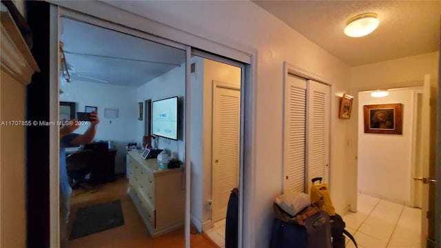 corridor featuring light tile patterned floors