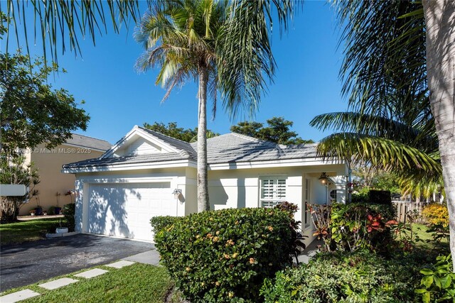 ranch-style house featuring a garage and a front yard