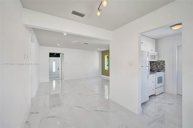 kitchen with decorative backsplash, white cabinetry, and white appliances