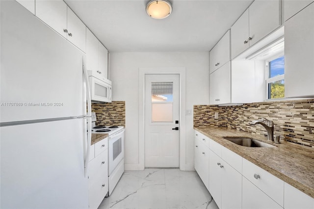 kitchen featuring light stone countertops, backsplash, white appliances, sink, and white cabinetry