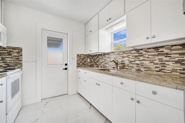 kitchen featuring white cabinetry, sink, light stone countertops, white appliances, and decorative backsplash