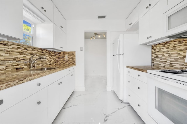 kitchen featuring white appliances, tasteful backsplash, white cabinetry, and sink