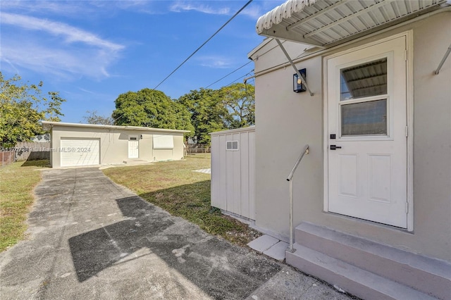 view of exterior entry featuring a lawn