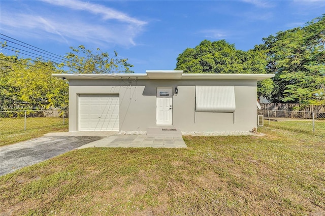 view of front of property with a front lawn and a garage