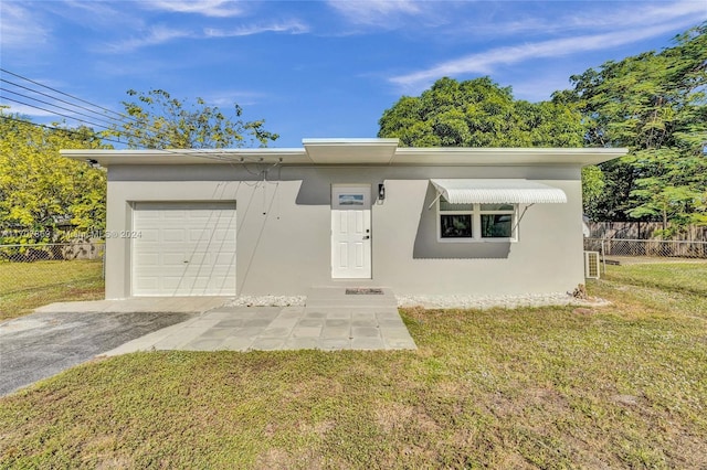 view of front facade with a garage and a front lawn