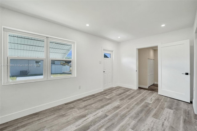 empty room with light hardwood / wood-style flooring