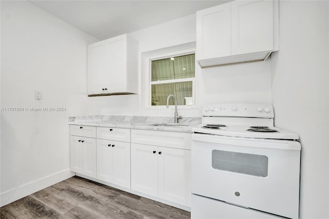 kitchen featuring electric range, sink, light stone counters, white cabinets, and light wood-type flooring