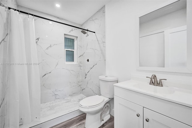 bathroom featuring hardwood / wood-style floors, vanity, toilet, and walk in shower