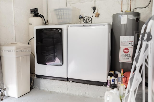 utility room with independent washer and dryer and water heater