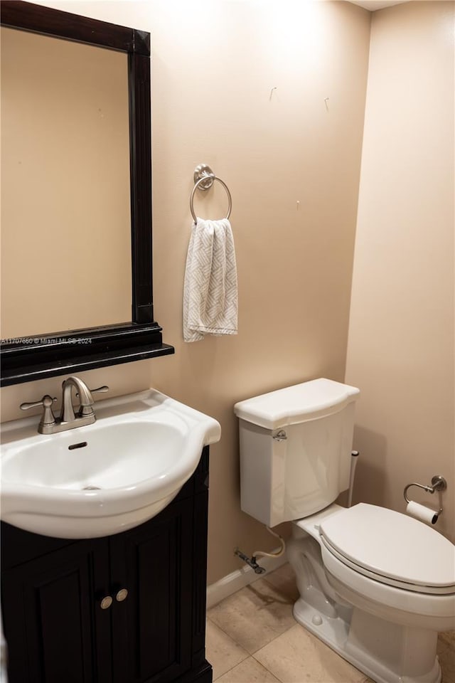 bathroom with tile patterned flooring, vanity, and toilet