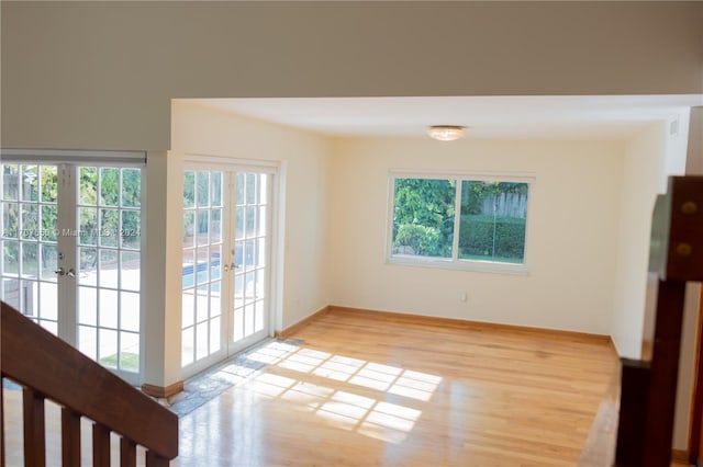 unfurnished room featuring light wood-type flooring and french doors