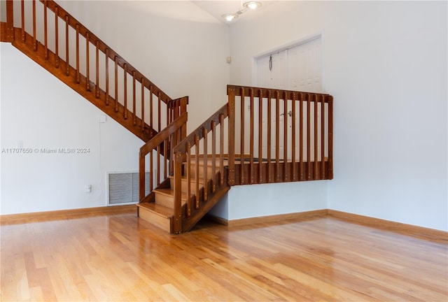 stairs with hardwood / wood-style floors