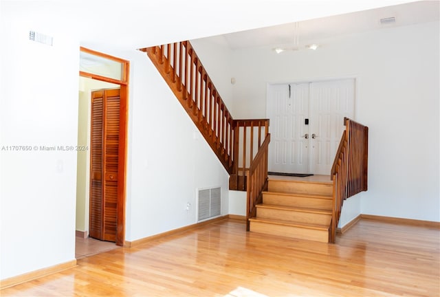 staircase with hardwood / wood-style floors