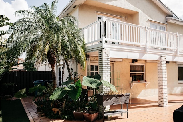 back of property with a balcony