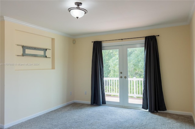 unfurnished room with carpet floors, ornamental molding, and french doors