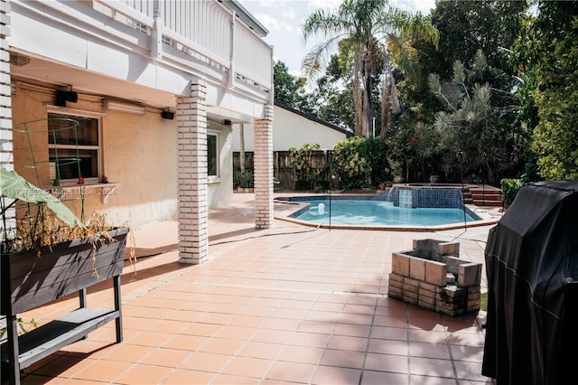 view of pool with a patio area, an in ground hot tub, and grilling area