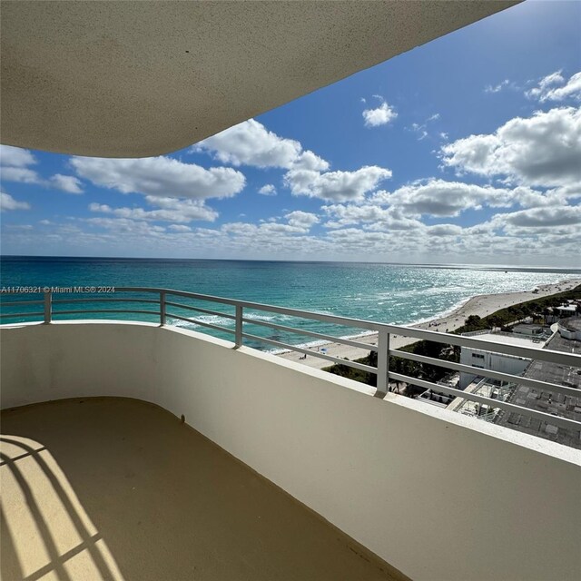 balcony with a view of the beach and a water view