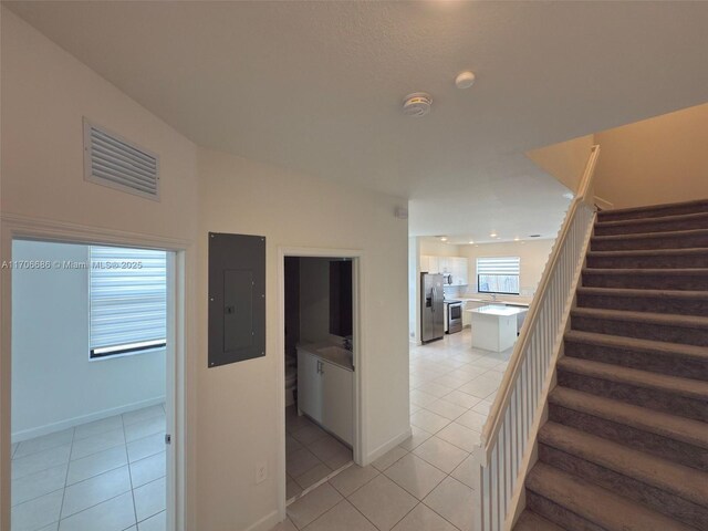 stairs featuring tile patterned flooring