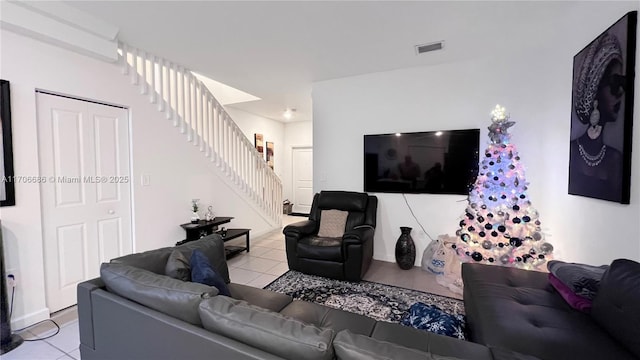 tiled living area with stairway and visible vents