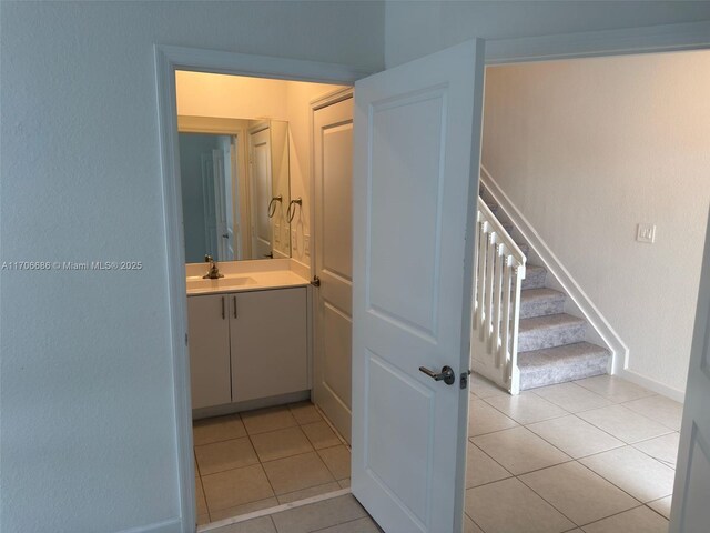 kitchen featuring white cabinets, light tile patterned floors, and a kitchen island