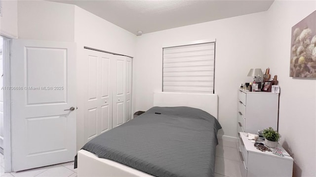 bedroom featuring light tile patterned floors and a closet