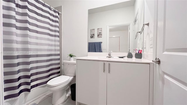 bathroom featuring tile patterned floors, a shower with shower curtain, toilet, and vanity