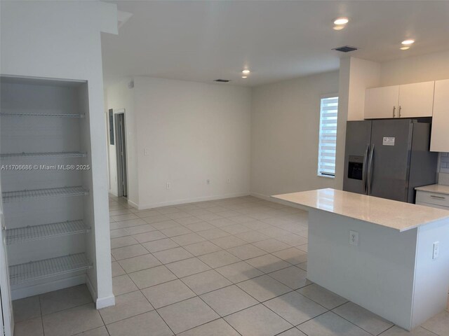 bedroom featuring light tile patterned floors and a closet