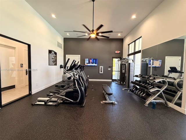 workout area featuring visible vents, baseboards, a high ceiling, and ceiling fan