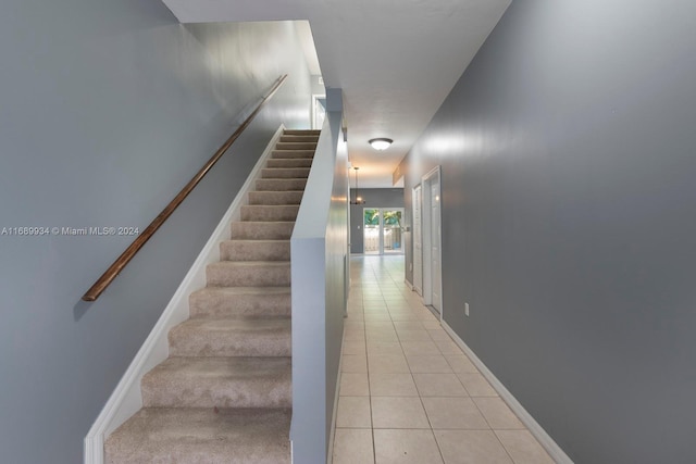 staircase featuring tile patterned floors