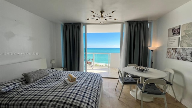 tiled bedroom featuring a water view, a wall of windows, and access to outside