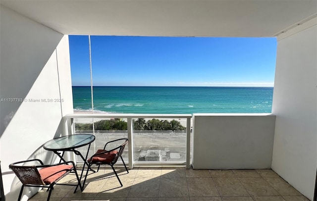 balcony featuring a water view and a view of the beach