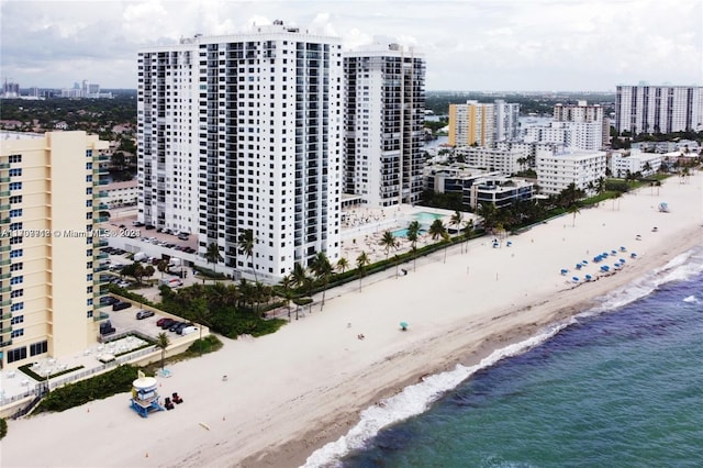 drone / aerial view with a water view and a beach view