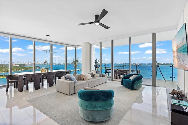 sunroom with a water view, a wealth of natural light, and ceiling fan