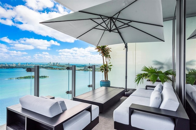 balcony featuring an outdoor living space and a water view