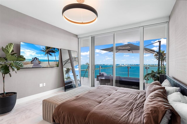 bedroom featuring a water view and access to outside