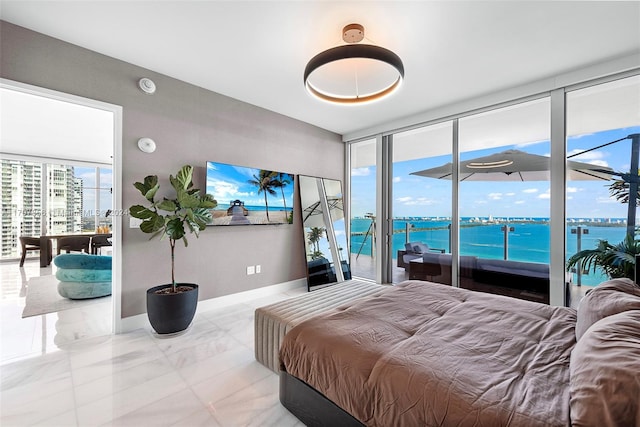 bedroom featuring access to outside and a wall of windows