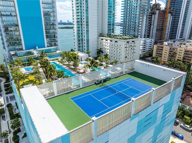 view of tennis court featuring a water view