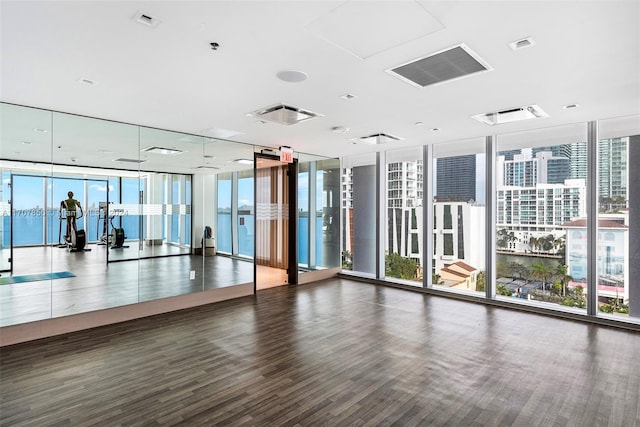 interior space featuring dark hardwood / wood-style floors and a wall of windows