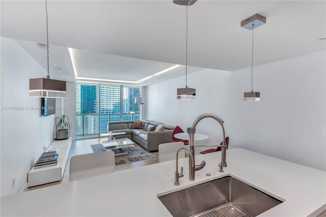 kitchen with sink, expansive windows, and pendant lighting