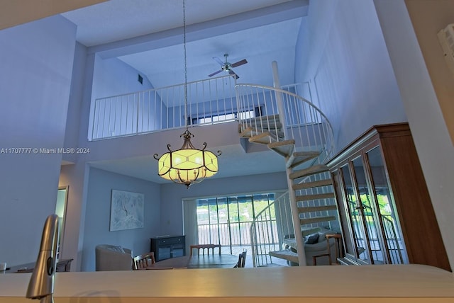 interior space with high vaulted ceiling and ceiling fan