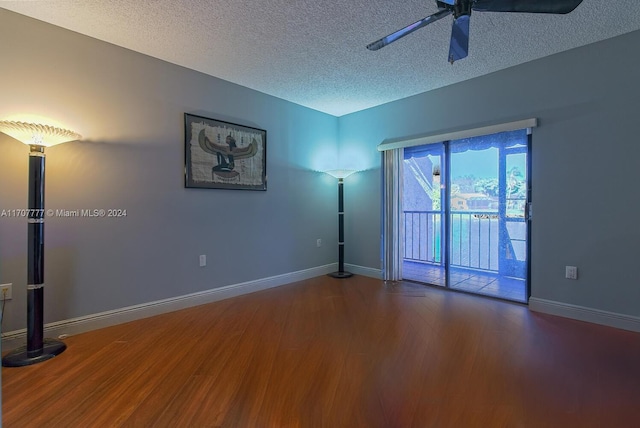 empty room featuring hardwood / wood-style floors, ceiling fan, and a textured ceiling