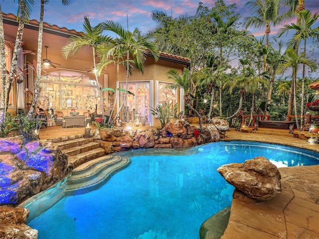 pool at dusk with an outdoor pool