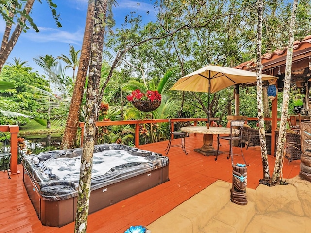 wooden deck with a hot tub