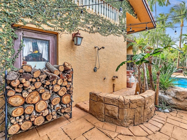 view of side of home featuring a patio area and stucco siding