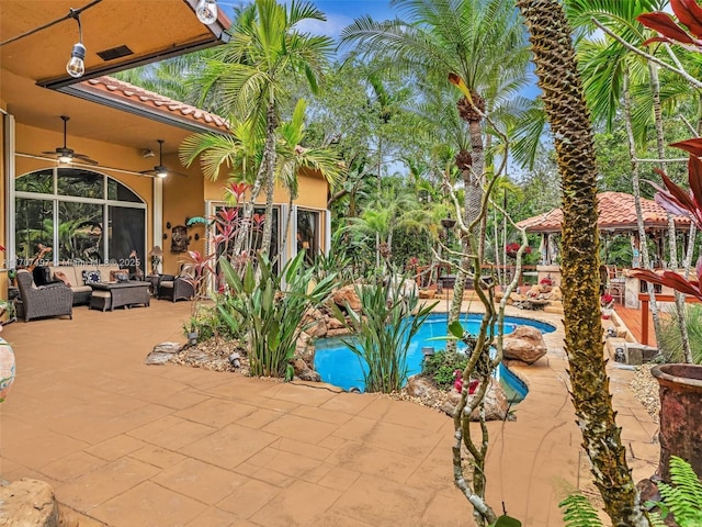 view of patio with ceiling fan, an outdoor hangout area, and a gazebo