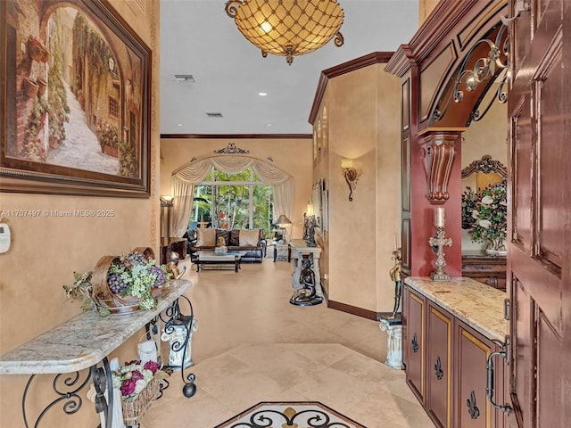 hallway featuring ornamental molding, recessed lighting, visible vents, and baseboards