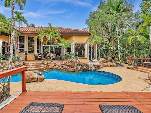 view of pool with a deck and a patio